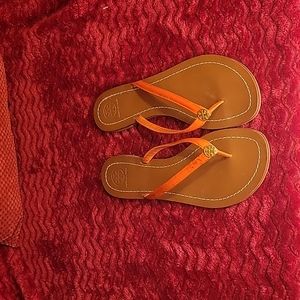 Tory Burch Terra orange patent leather thong sandals.